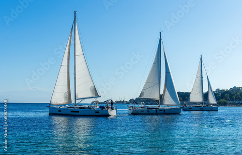 sailing yacht boats with white sails in blue sea , seascape of beautiful ships in sea gulf with mountain coast on background © Yaroslav