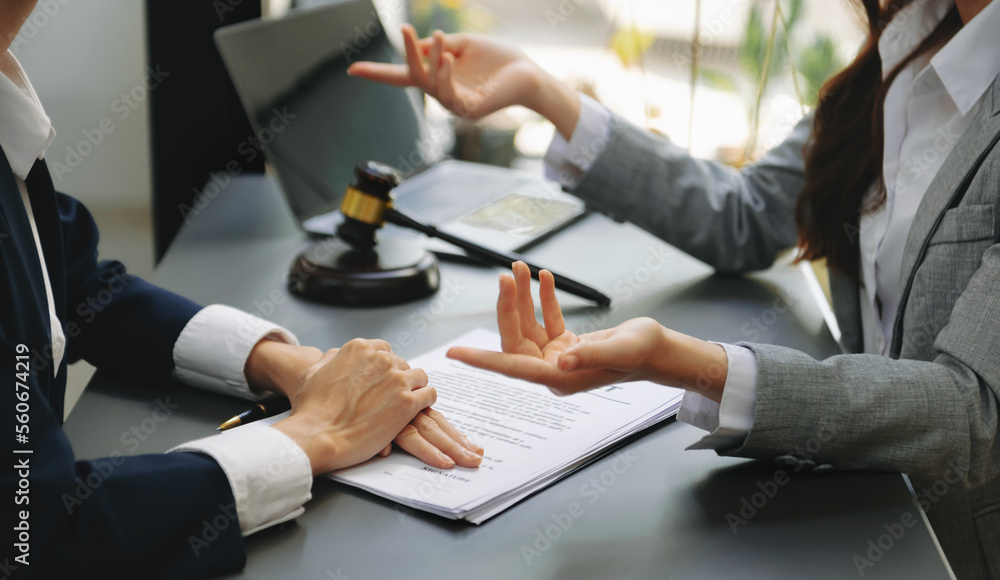 Fototapeta Business law concept, Lawyer business lawyers are consulting lawyers for women entrepreneurs to file copyright lawsuit with laptop and tablet