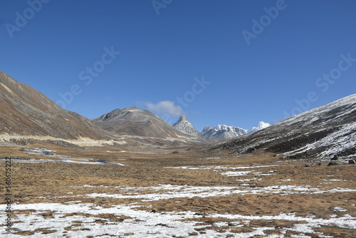 Panoramic landscape view of beautiful snowcapped Zero Point, or Yumesamdong, and distant Himalayan peaks. It is famous for tourism in Sikkim, India.