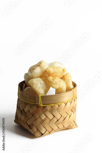 Rambak or Karupuak Jangek or Kerupuk Kulit  is a Indonesian Traditional Cattle or Cow Skin Cracker. Rambak in besek, isolated on white background.