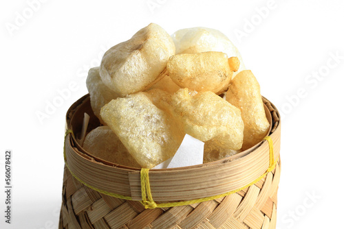Rambak or Karupuak Jangek or Kerupuk Kulit  is a Indonesian Traditional Cattle or Cow Skin Cracker. Rambak in besek, isolated on white background.