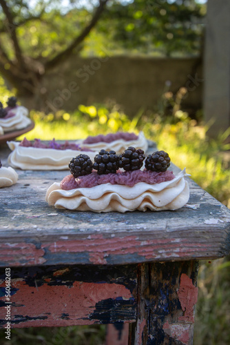 Dessert Anna Pavlova with fresh blackberries and buttercream.