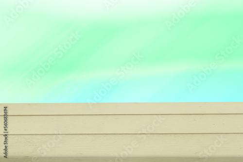 Wooden table on green blue gradient blurred background for placement of products