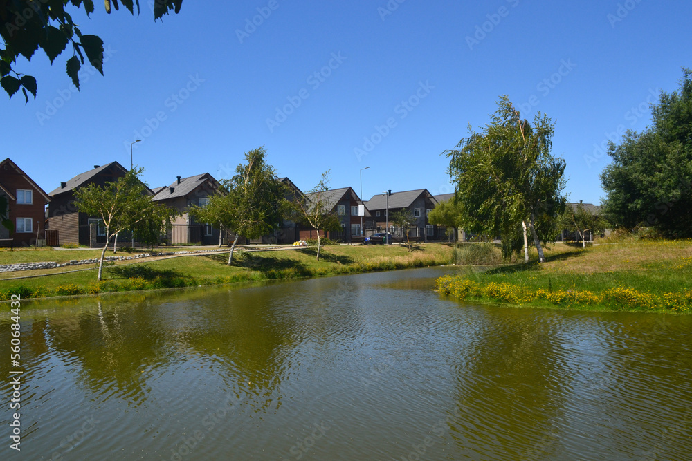 a beautiful river near a housing estate in the summer time
