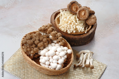 Mushrooms. Fresh Organic, enoki, shiitaki,  button mushrooms in wooden woven basket at a restaurant. Variety of Mushrooms in a basket,  photo