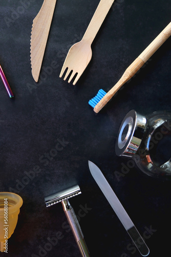 Various sustainable beauty products and kitchen utensils on dark background. Top view.