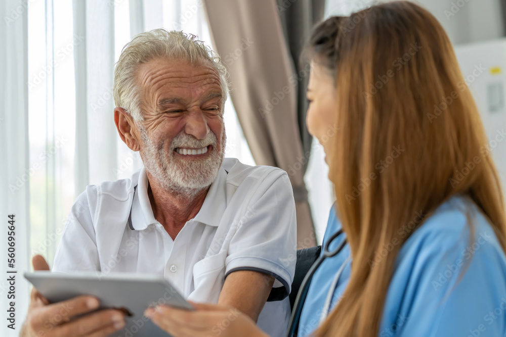 Man being cared for by a private Asian nurse at home suffering from Alzheimer's disease to closely care for elderly patients with copy space on left Man being cared for by a private Asian nurse at home suffering from Alzheimer's disease to closely care for elderly patients with copy space on left