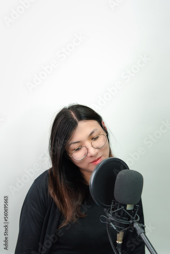 Woman (LGBTQ) singer sing a song with microphone