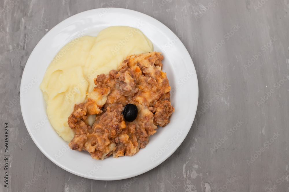 Minced meat and mashed potato on white plate Minced meat and mashed potato on white plate