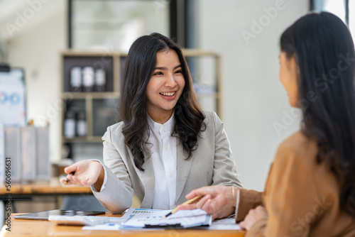 Asian female sales representatives in the section of Real estate talked and discussed tax plans to search for information Ask questions and give advice. All information is recorded and detailed.