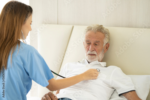 Man being cared for by a private Asian nurse at home suffering from Alzheimer s disease to closely care for elderly patients with copy space on left