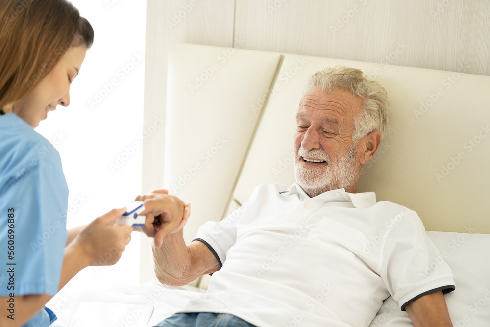 Man being cared for by a private Asian nurse at home suffering from Alzheimer's disease to closely care for elderly patients with copy space on left