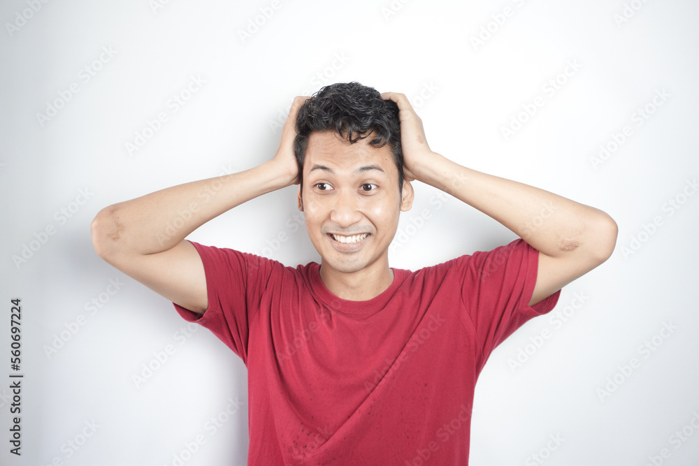 Emotionally frightened black haired man, seen with a frightened expression upon seeing something horrific ahead, looks nervously at the camera, showing phobia. Human reactions and emotions Emotionally frightened black haired man, seen with a frightened expression upon seeing something horrific ahead, looks nervously at the camera, showing phobia. Human reactions and emotions