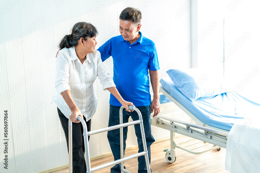The husband is closely caring for his Asian wife who is being treated at the hospital. with love for each other, the concept of love for the elderly The husband is closely caring for his Asian wife who is being treated at the hospital. with love for each other, the concept of love for the elderly