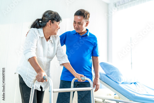 The husband is closely caring for his Asian wife who is being treated at the hospital. with love for each other, the concept of love for the elderly