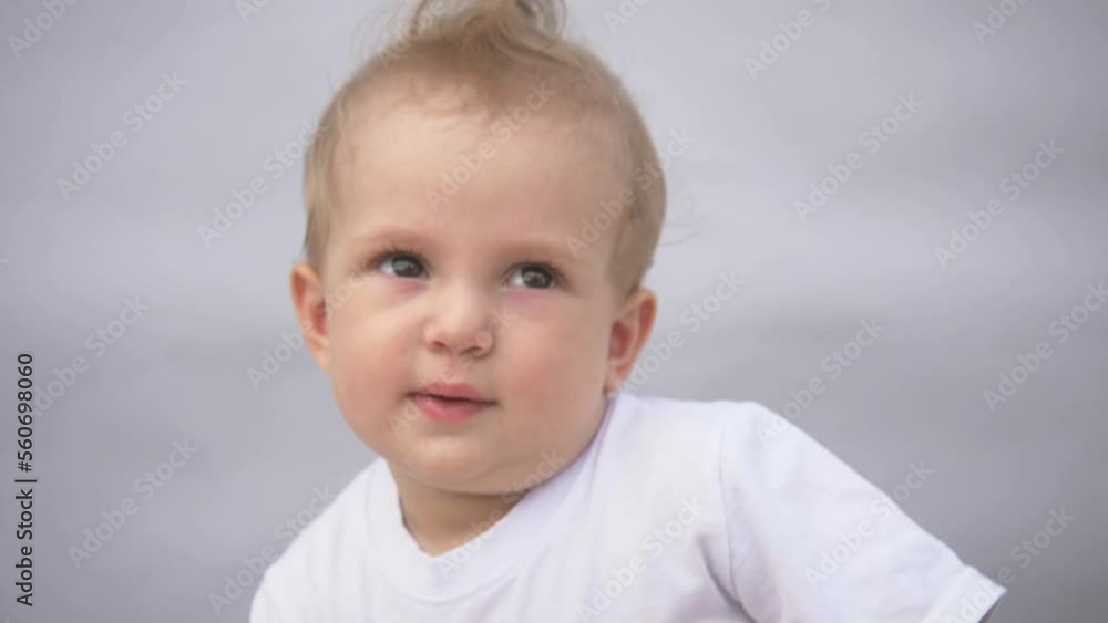 Beautiful smiling cute baby. Portrait of a happy child on a blue background. Funny happy child smiling at the camera. Beautiful smiling cute baby. Portrait of a happy child on a blue background. Funny happy child smiling at the camera.