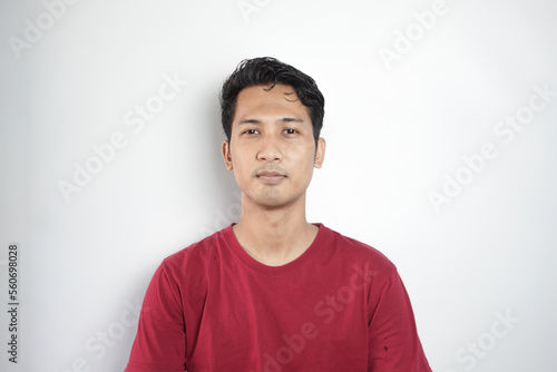 Φωτογραφία Young asian Indonesia man wearing t-shirt standing over isolated white background Relaxed with serious expression on face