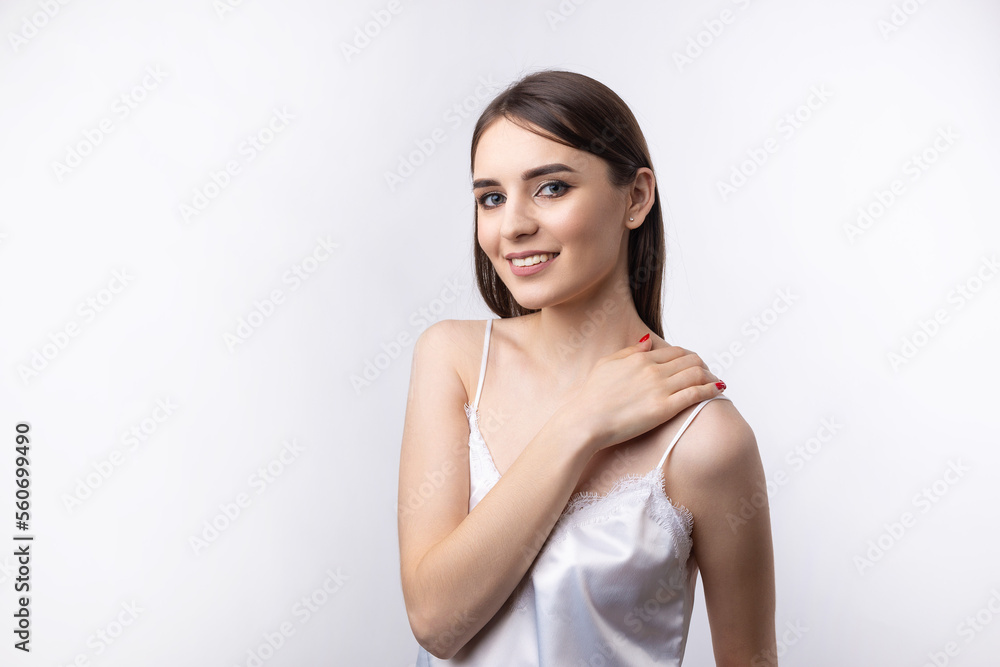 Beautiful smiling woman with clean skin, natural make-up and white teeth on a gray background Beautiful smiling woman with clean skin, natural make-up and white teeth on a gray background