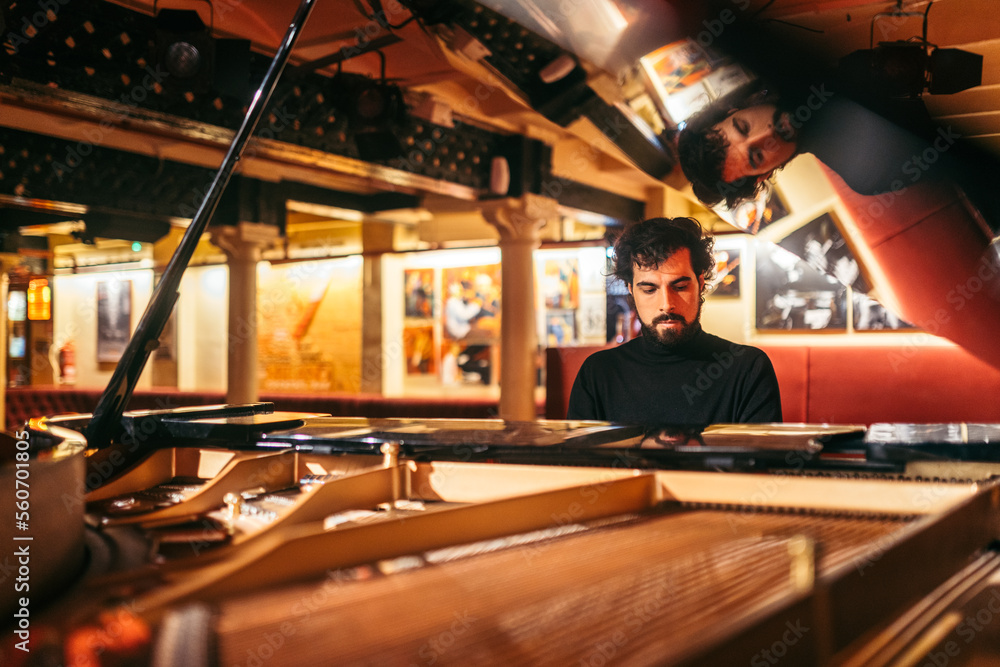 Man playing piano in a club Man playing piano in a club