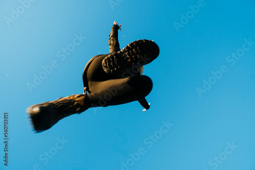 nadir photography of woman jumping against blue sky photo