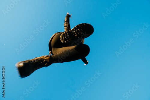 nadir photography of woman jumping against blue sky