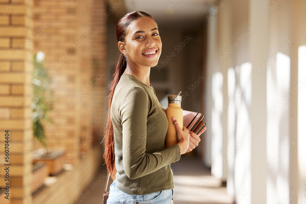 Woman portrait, university student and college books and water bottle while walking at campus with a smile. Gen z female happy about education, learning and future after studying at school building - obrazy, fototapety, plakaty 