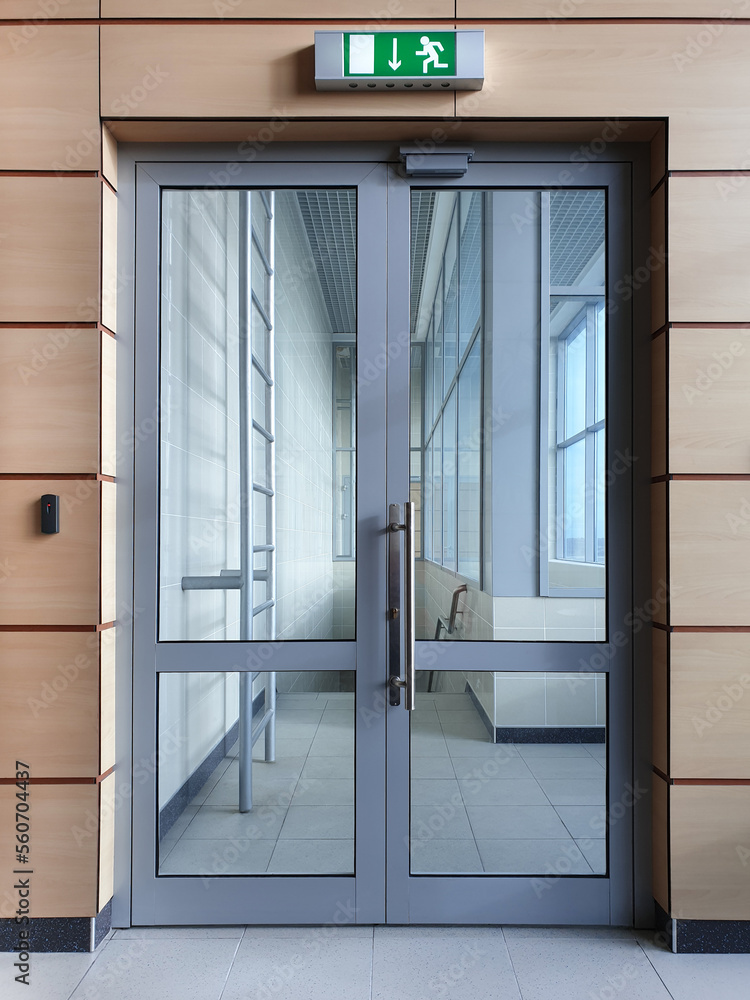 Emergency exit with glass door in airport office building