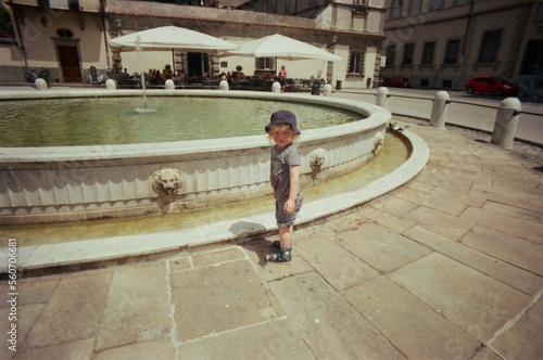 Toddler and a fountain in Italian town photo