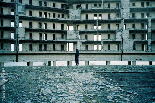 Anonymous man in front of an abandoned building photo