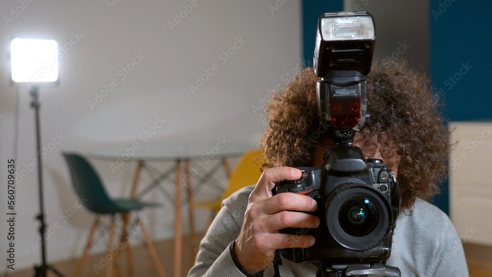 Photographer man taking pictures and video in apartment - real estate home photoshoot for selling house whit professional estate agency - home staging and enhance the property for advertising