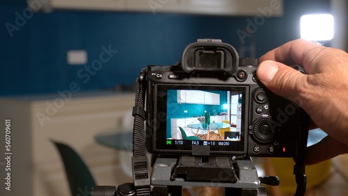 Obraz na płótnie Photographer man taking pictures and video in apartment - real estate home photoshoot for selling house whit professional estate agency - home staging and enhance the property for advertising w salonie
