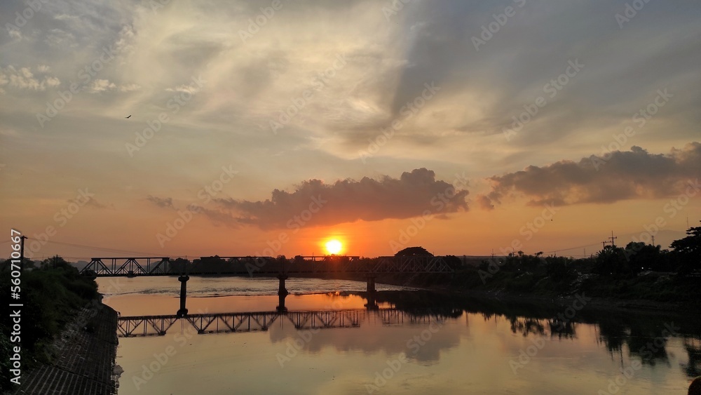 Natural beautiful silhouettes scenery sunrise background of bridge on the river during sunrise