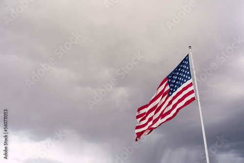 American flag against stormy clouds
