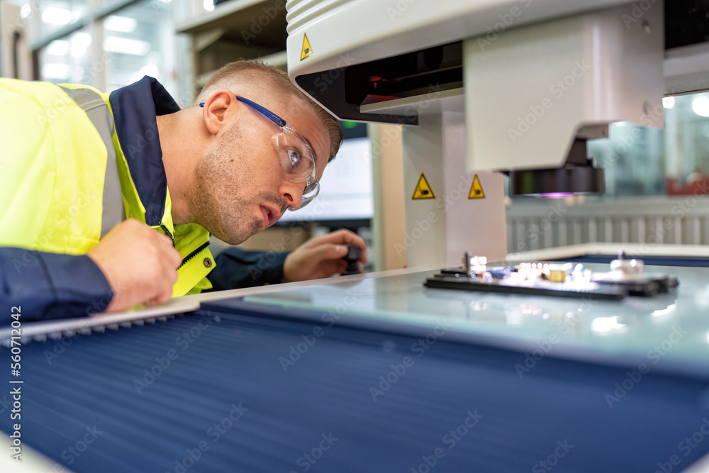 Engineer sitting in robot fabrication room use measuring microscope machine check electronic board Engineer sitting in robot fabrication room use measuring microscope machine check electronic board