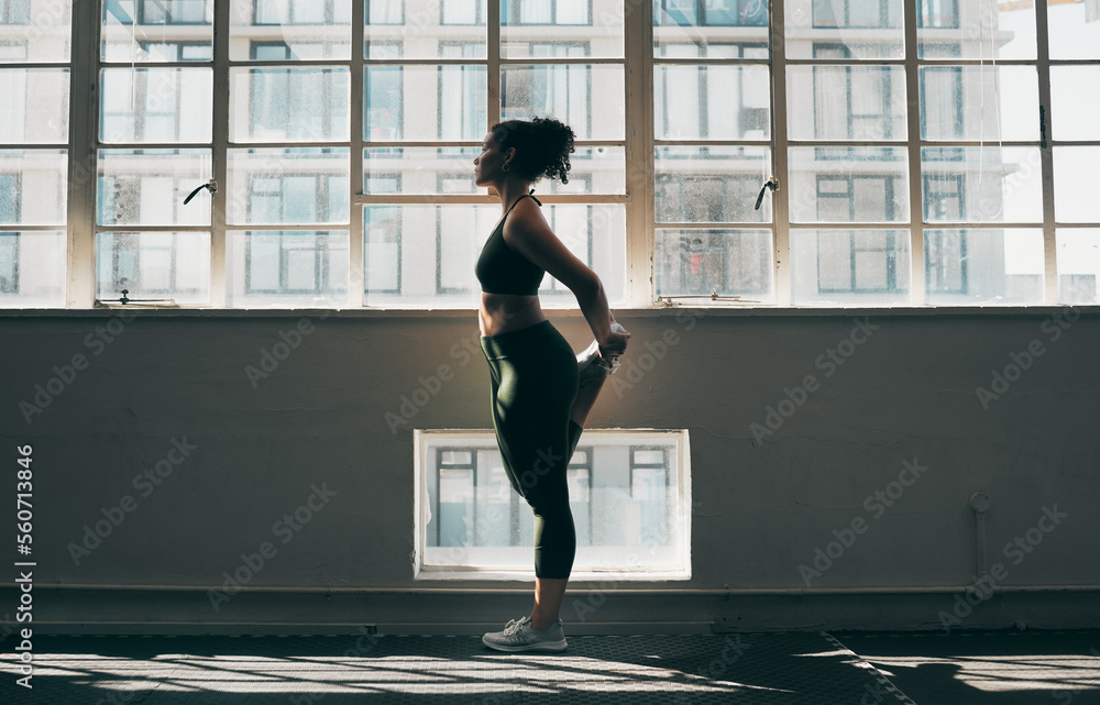 Exercise, stretching and a woman at gym for fitness workout for health and body wellness with muscle warm up. Sports female or athlete stretch legs at window for balance, energy and healthy lifestyle - obrazy, fototapety, plakaty 