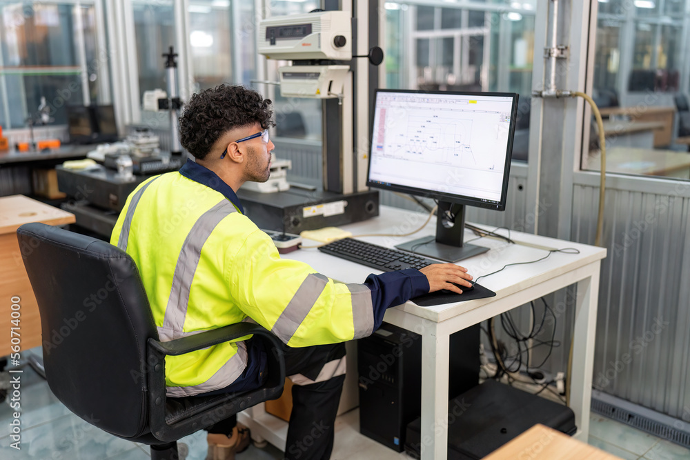 Engineer sitting in robot electronic room use computer create process analogue and logic diagram Engineer sitting in robot electronic room use computer create process analogue and logic diagram