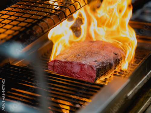 Meat being flamed and grilled.  photo