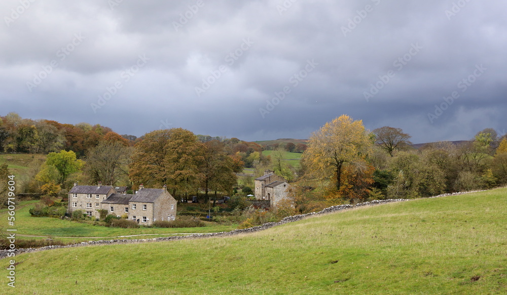 Wharfedale, Yorkshire. Rain Clouds gather over rural hamlet in beautiful countryside.