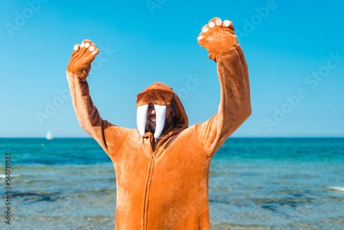 Walrus on the beach excitedly cheering with his hands up photo