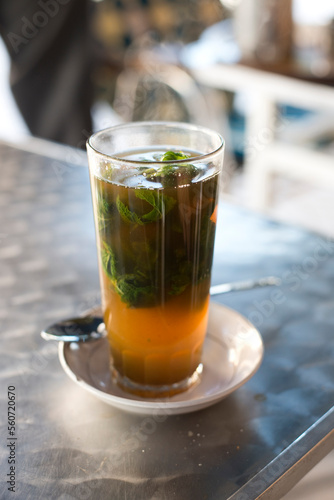 A glass of traditional Moroccan mint tea at a cafe in Asilah, Morocco. photo