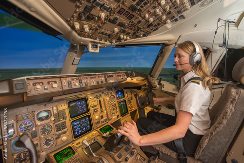 Female pilot in flight simulator during training photo