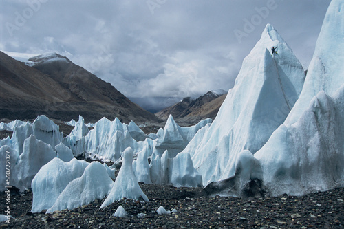 An ice climber climbs an ice tower on the Rongbuk Glacier, Tibet. photo