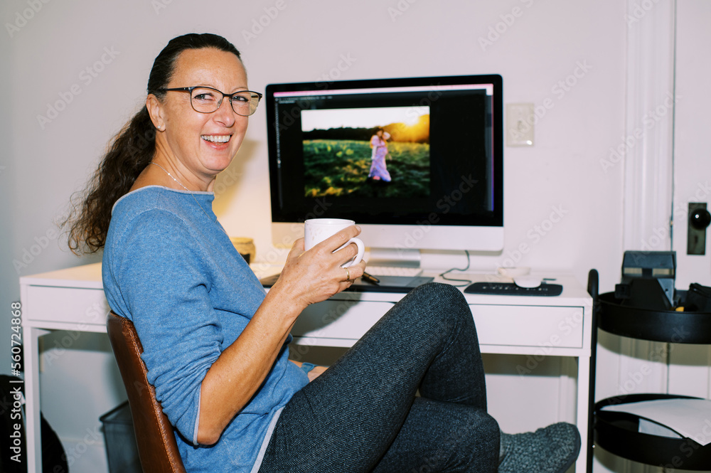 Middle Aged Photographer Working at her Home Office Middle Aged Photographer Working at her Home Office