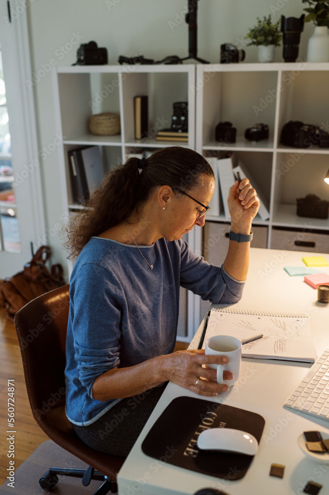 Middle Aged Photographer Working at her Home Office Middle Aged Photographer Working at her Home Office