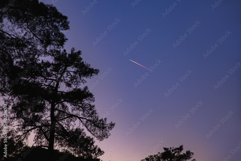 A bright comet in the sky, a shooting star. Comet tail at sunset. Selective focus. A bright comet in the sky, a shooting star. Comet tail at sunset. Selective focus.