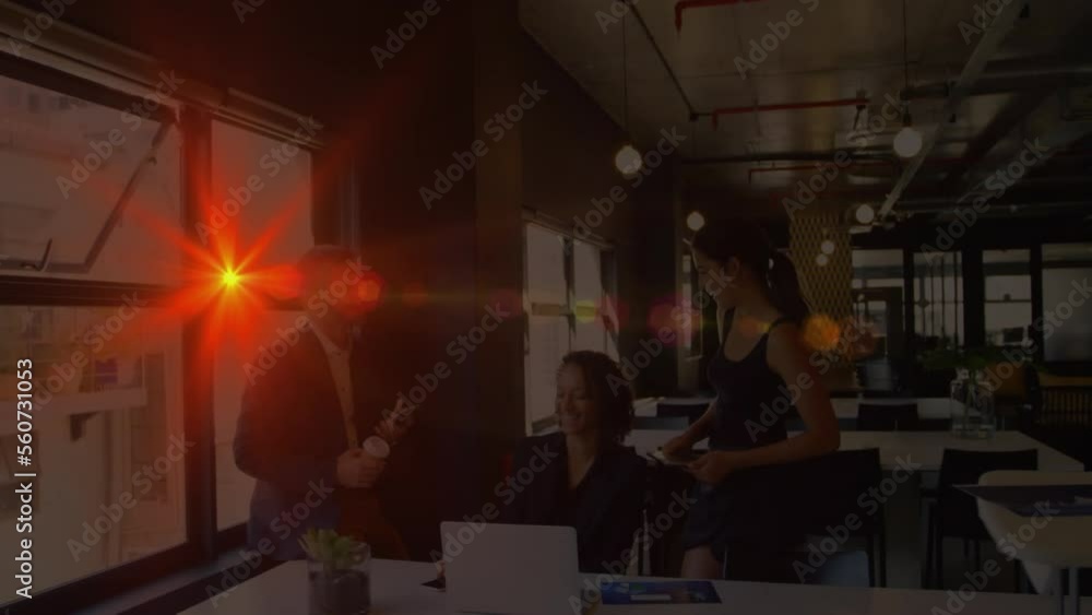 Animation of light spots over diverse business people working in office Animation of light spots over diverse business people working in office