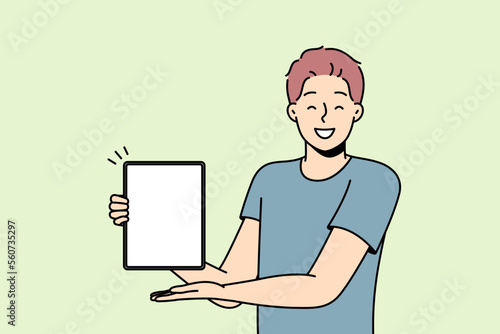 Smiling young man show tablet with mockup screen. Happy male demonstrate empty blank screen on pad device demonstrate good offer or deal. Vector illustration. 