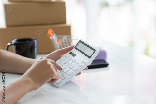 Online shopping delivery, start up, small business owner, work from home, small business entrepreneur, SME or freelance Asian woman working with boxes at home.