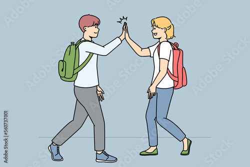 Smiling schoolchildren walking outdoors give high five. Happy friends greeting using non-verbal communication. Vector illustration. 