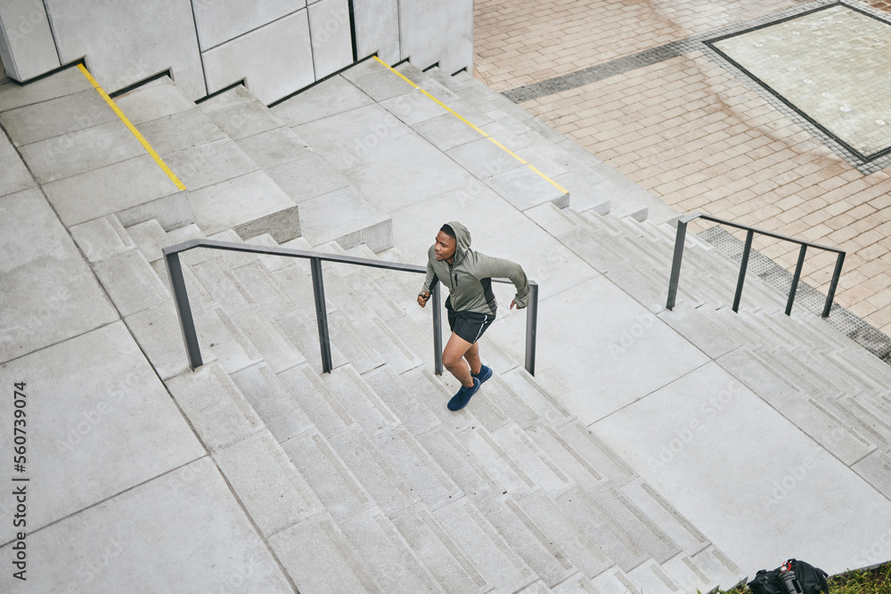 Running stairs and city with a sports black man from above for a